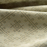 Close-up of textured green fabric with geometric pattern
