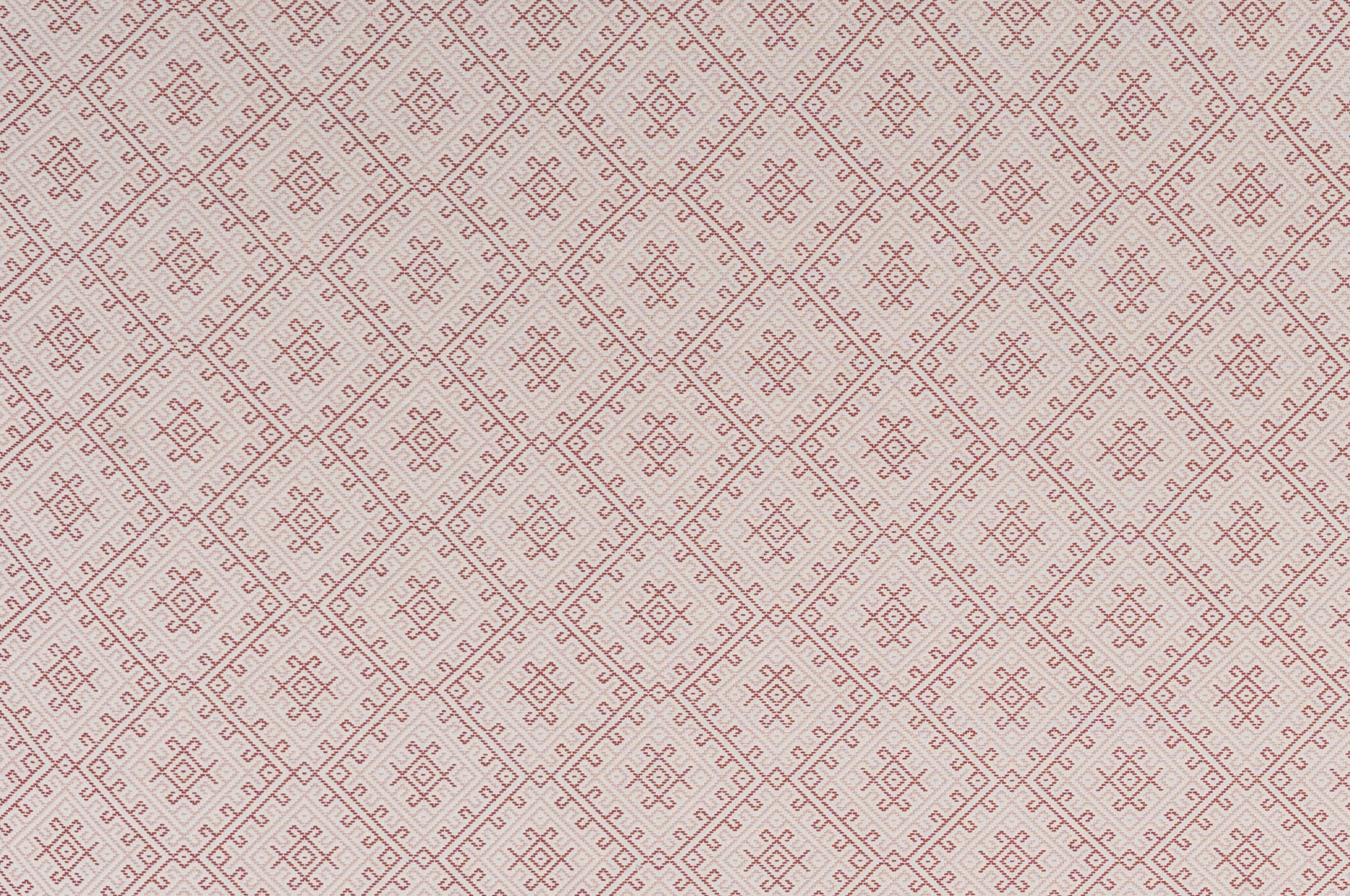 Textured fabric with a diamond pattern in red on white. 