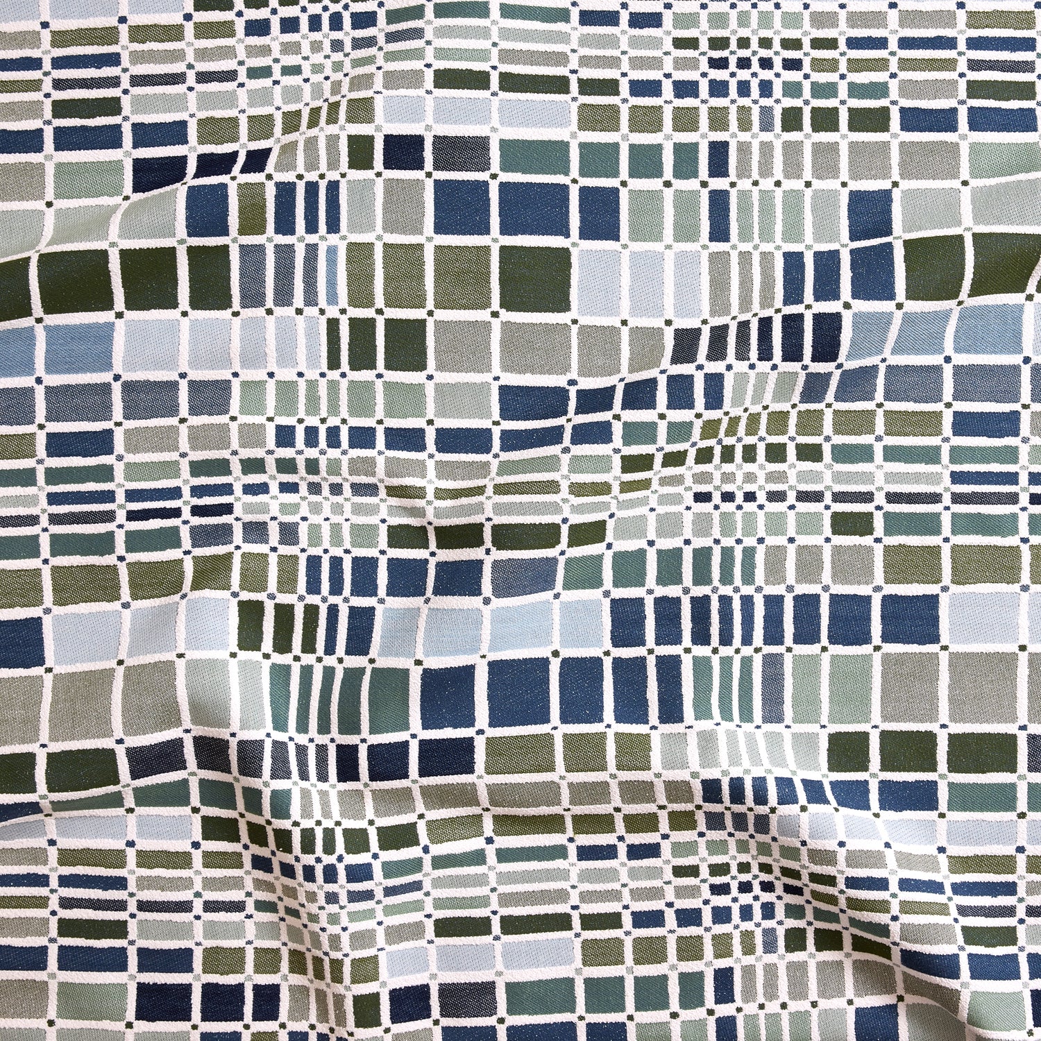 Close up of gently draped woven Indoor-Outdoor fabric with complex windowpane pattern in white with squares of olive green, dark green, light blue and navy.