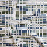 Close up of gently draped woven Indoor-Outdoor fabric with complex windowpane pattern in white with squares of olive green, dark green, light blue and navy.