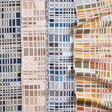 Gently draped fabric cuttings with complex window pane plaid in various colors. 