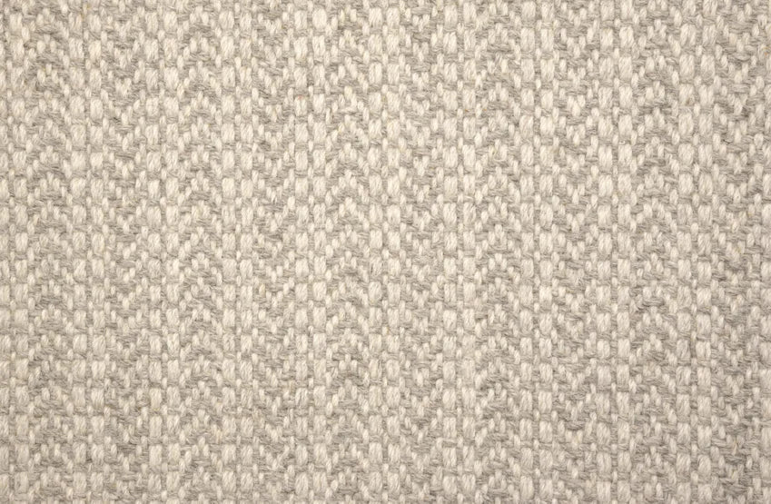 Broadloom carpet swatch in a herringbone pattern in a light grey design