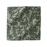Woven fabric painterly botanical lace pattern in green. 