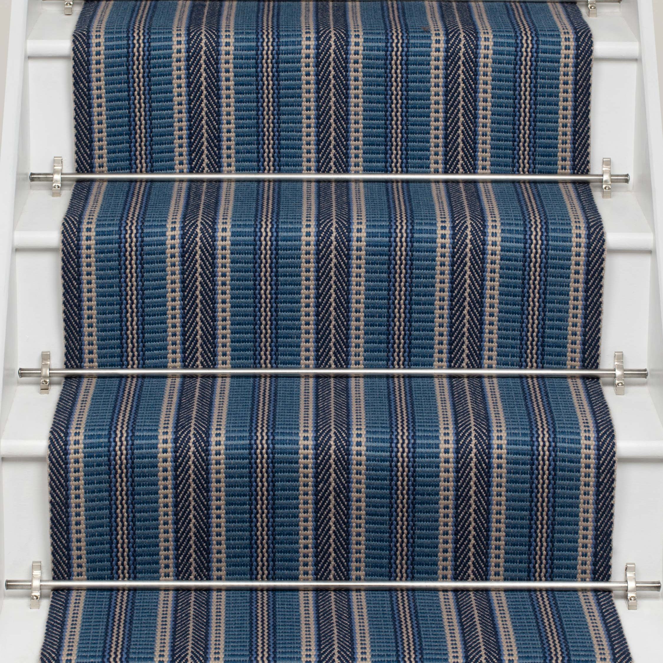 Striped flatweave runner in blue and black on white staircase