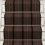 Striped flatweave runner in orange brown and black on white staircase