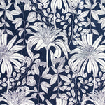 Detail of fabric in a floral print in black and white on a navy field.