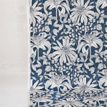 Draped fabric yardage in a floral print in black and white on a navy field.