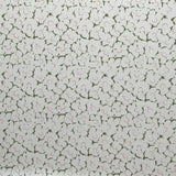 Fabric in a minimal floral print in coral and green on a cream field.