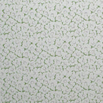 Fabric in a minimal floral print in purple and green on a gray field.