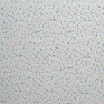 Fabric in a minimal floral print in red and blue on a light gray field.