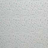 Fabric in a minimal floral print in red and blue on a light gray field.