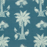 Detail of fabric in a playful palm tree print in white and navy on a blue field.