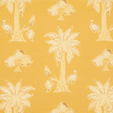 Detail of fabric in a playful palm tree print in tan and white on a yellow field.