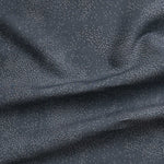 Detail of gently draped printed fabric with a white celestial dotted pattern on a cool blue background.