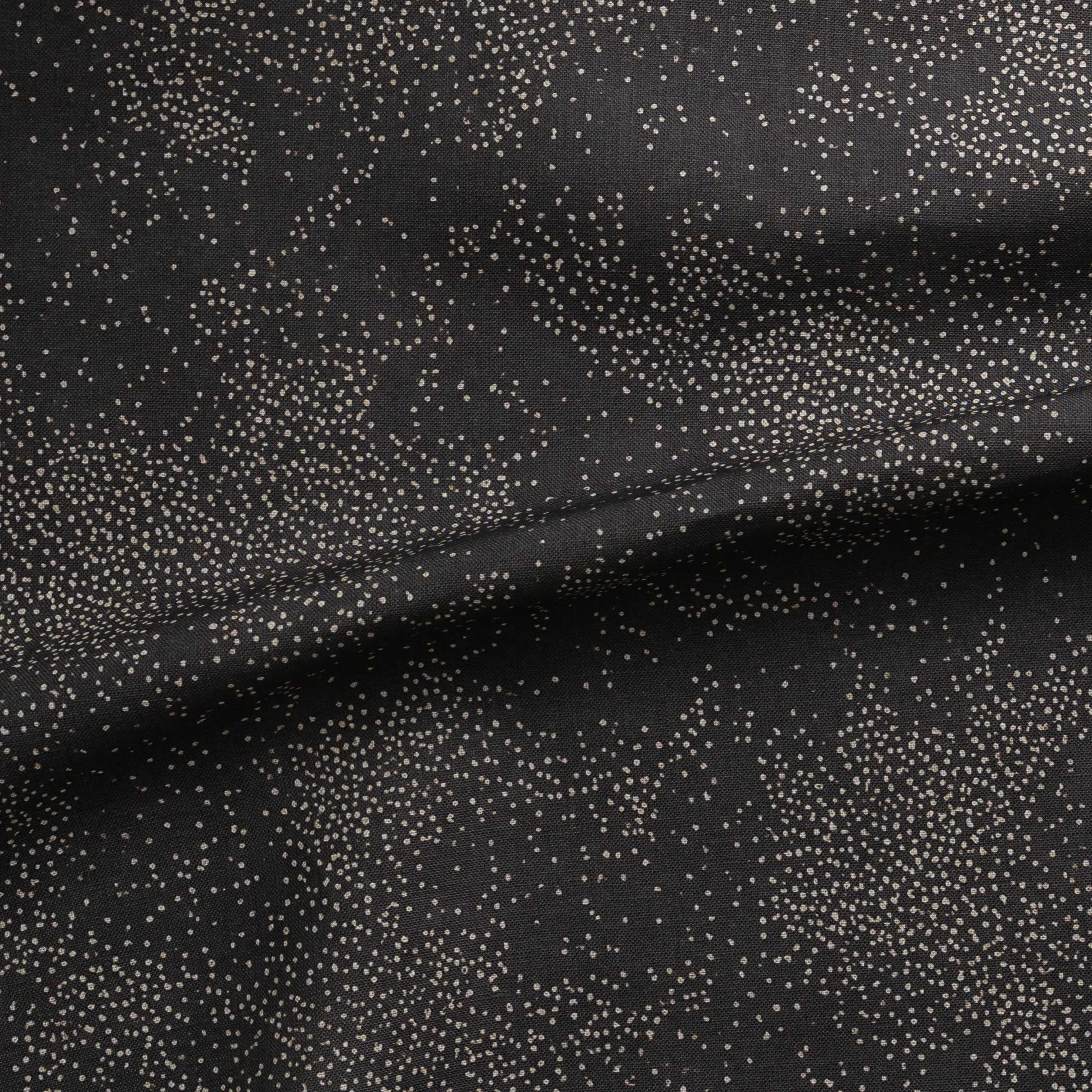 Detail of gently draped printed fabric with a white celestial dotted pattern on a muted black background. 