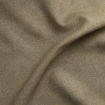 Detail of gently draped printed fabric with a white celestial dotted pattern on a soft tan background. 