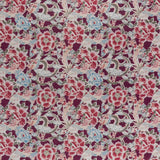 printed linen fabric in a painterly floral pattern in shades of blue, green and pink on a maroon field.