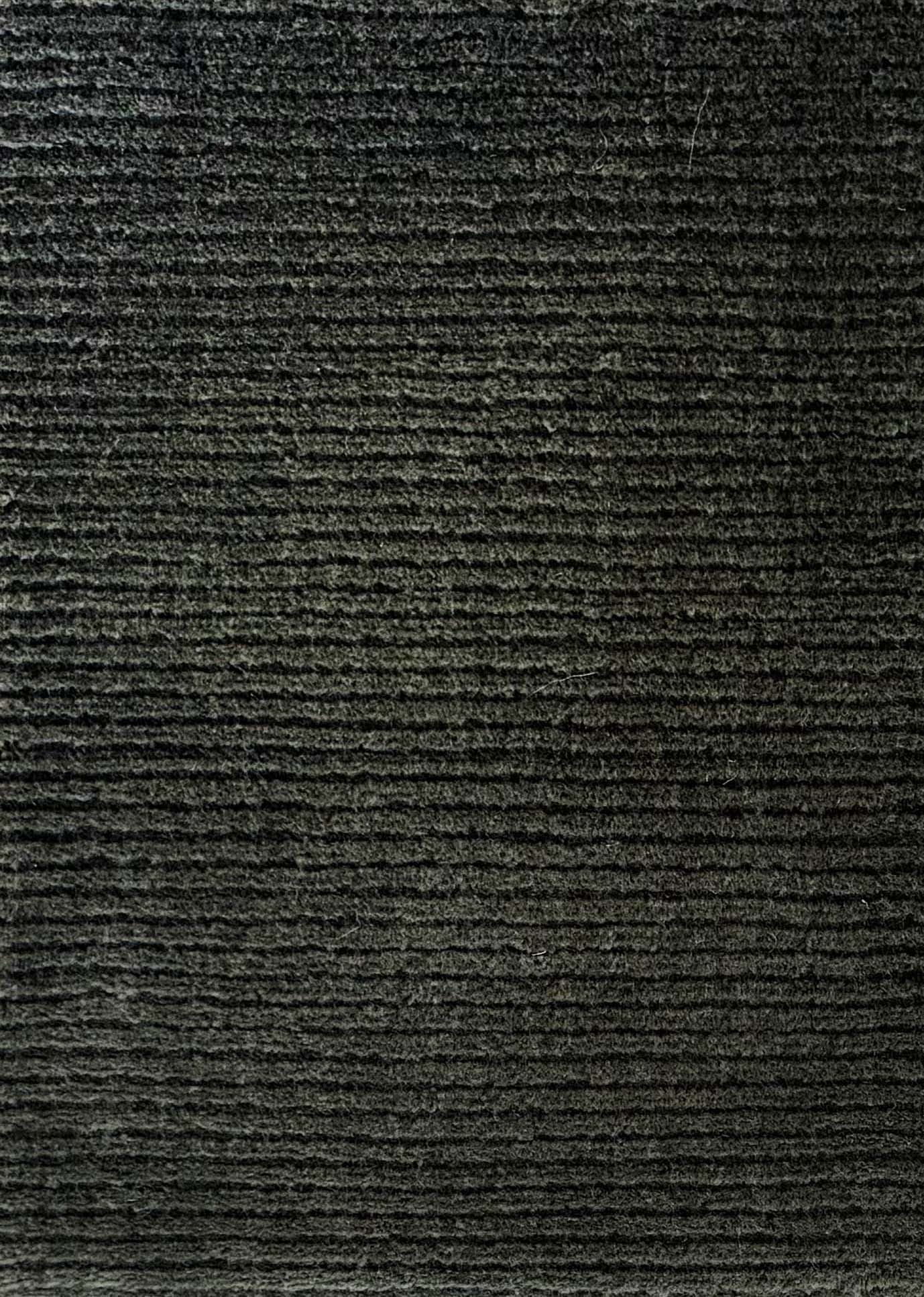 Close up of broadloom carpet with solid cut pile ribbed stripe in dark green.