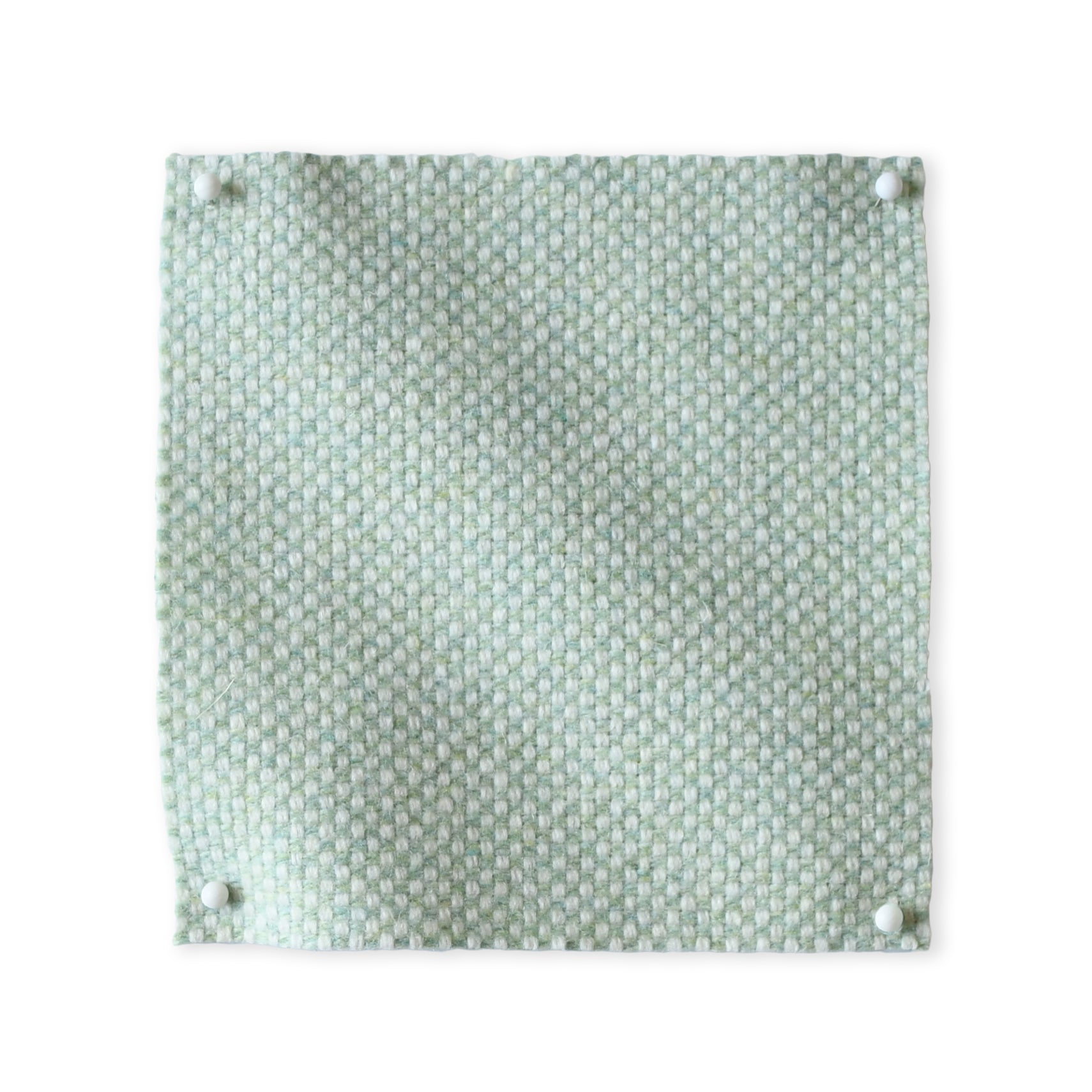 Pinned swatch of woven fabric in light aqua