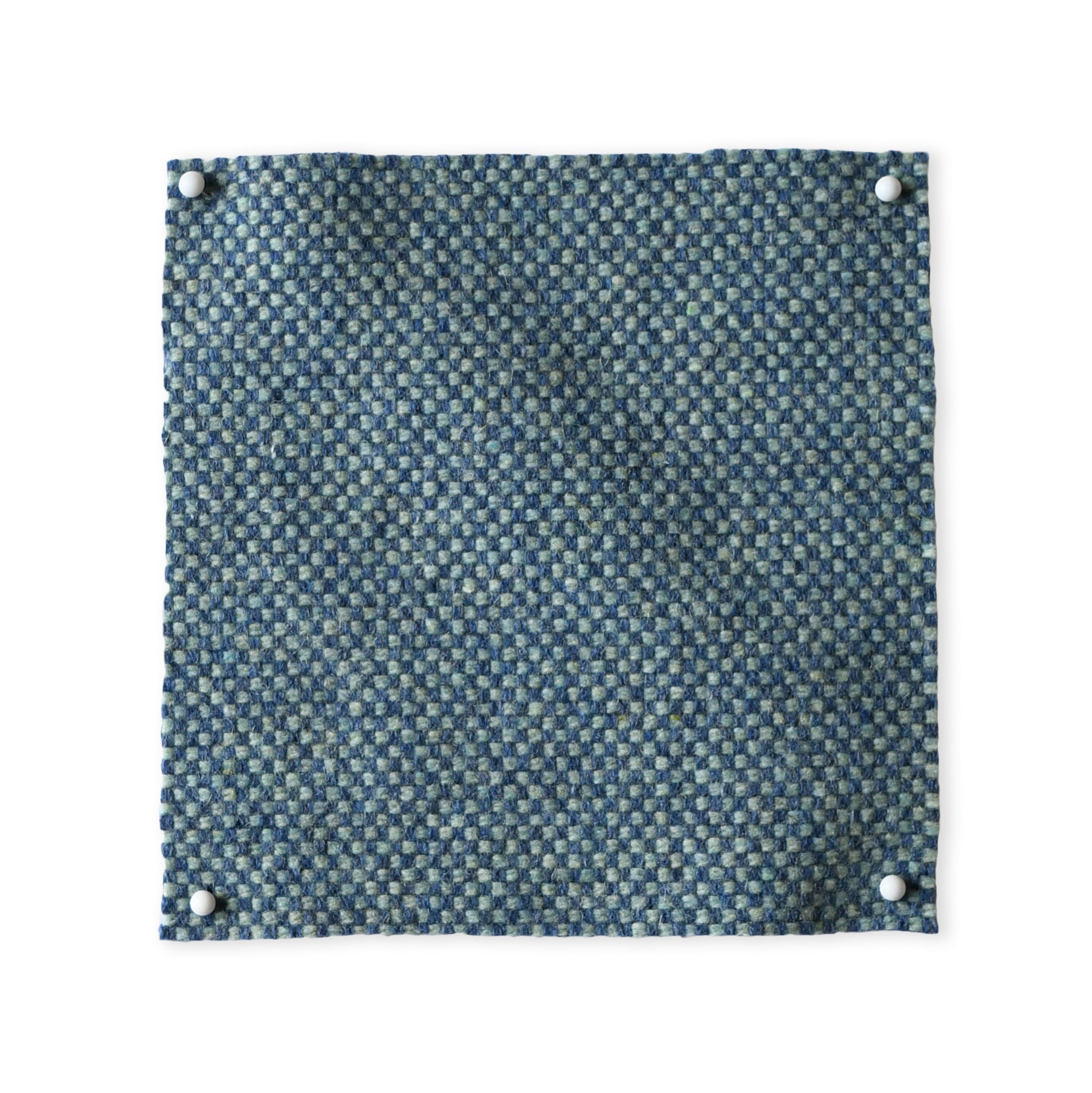 Pinned swatch of woven fabric in blue. 