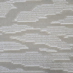 Broadloom carpet detail in an abstract cloud design in cream and taupe.