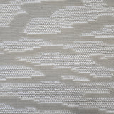 Broadloom carpet detail in an abstract cloud design in cream and taupe.