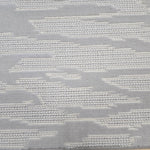 Broadloom carpet detail in an abstract cloud design in ivory and light grey.