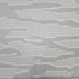 Broadloom carpet detail in an abstract cloud design in ivory and light grey.