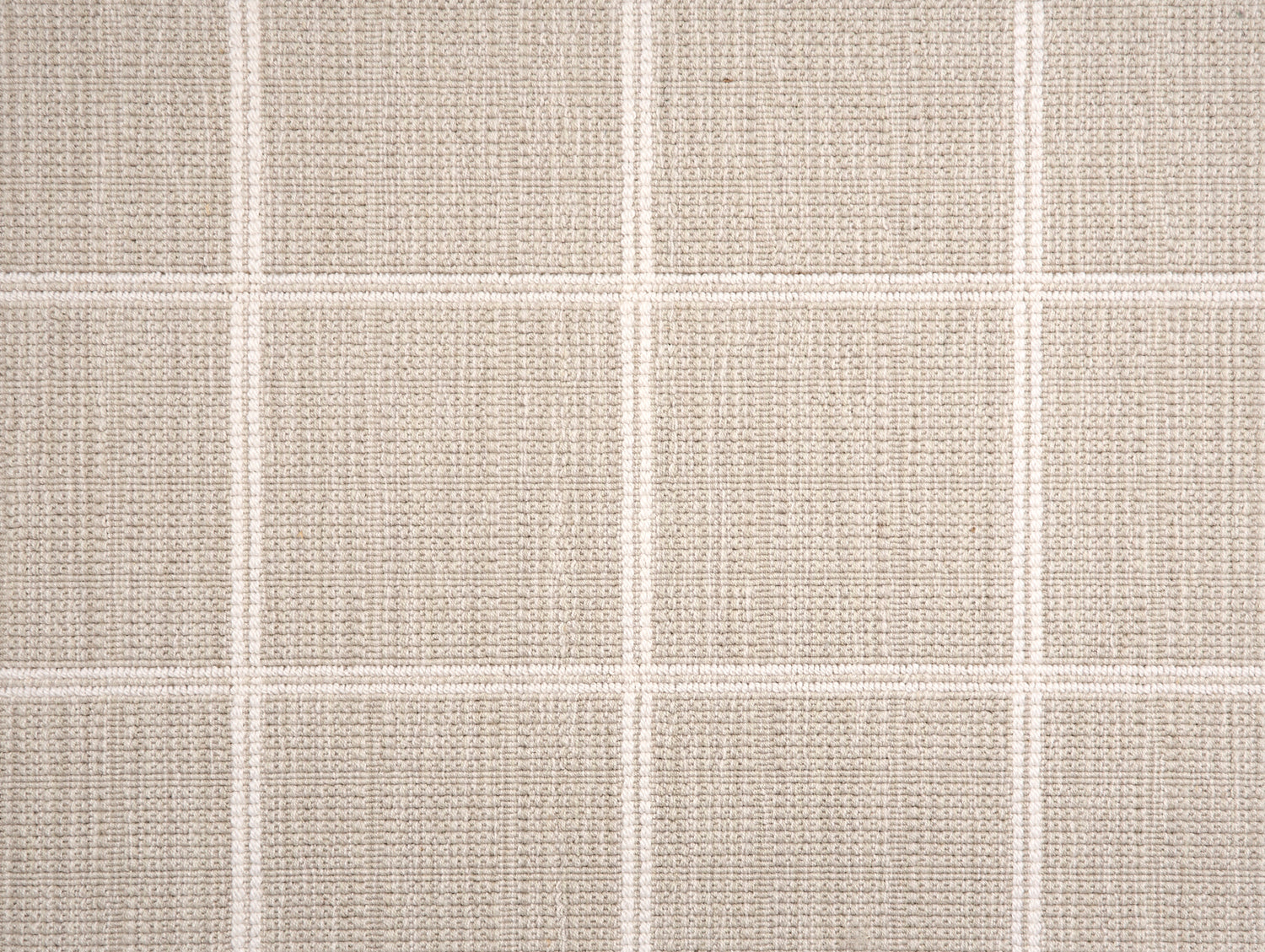 Broadloom carpet sample with windowpane grid in cream on a beige background. 