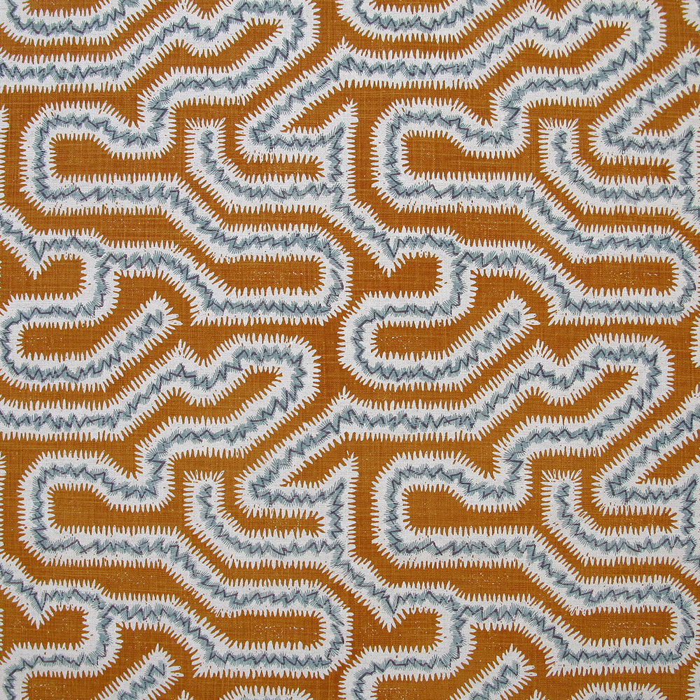 Detail of fabric in a dense meandering print in white, blue and gray on a burnt orange field.