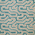 Detail of fabric in a dense meandering print in white, brown and pink on a turquoise field.