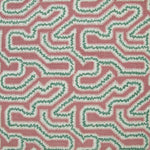 Detail of fabric in a dense meandering print in white and green on a pink field.