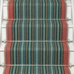 Striped flatweave runner in red blue and green black on white staircase