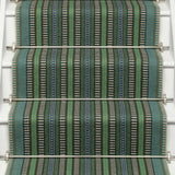 Striped flatweave runner in green blue black on white staircase