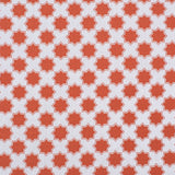 Moroccan star performance fabric in orange on white. 