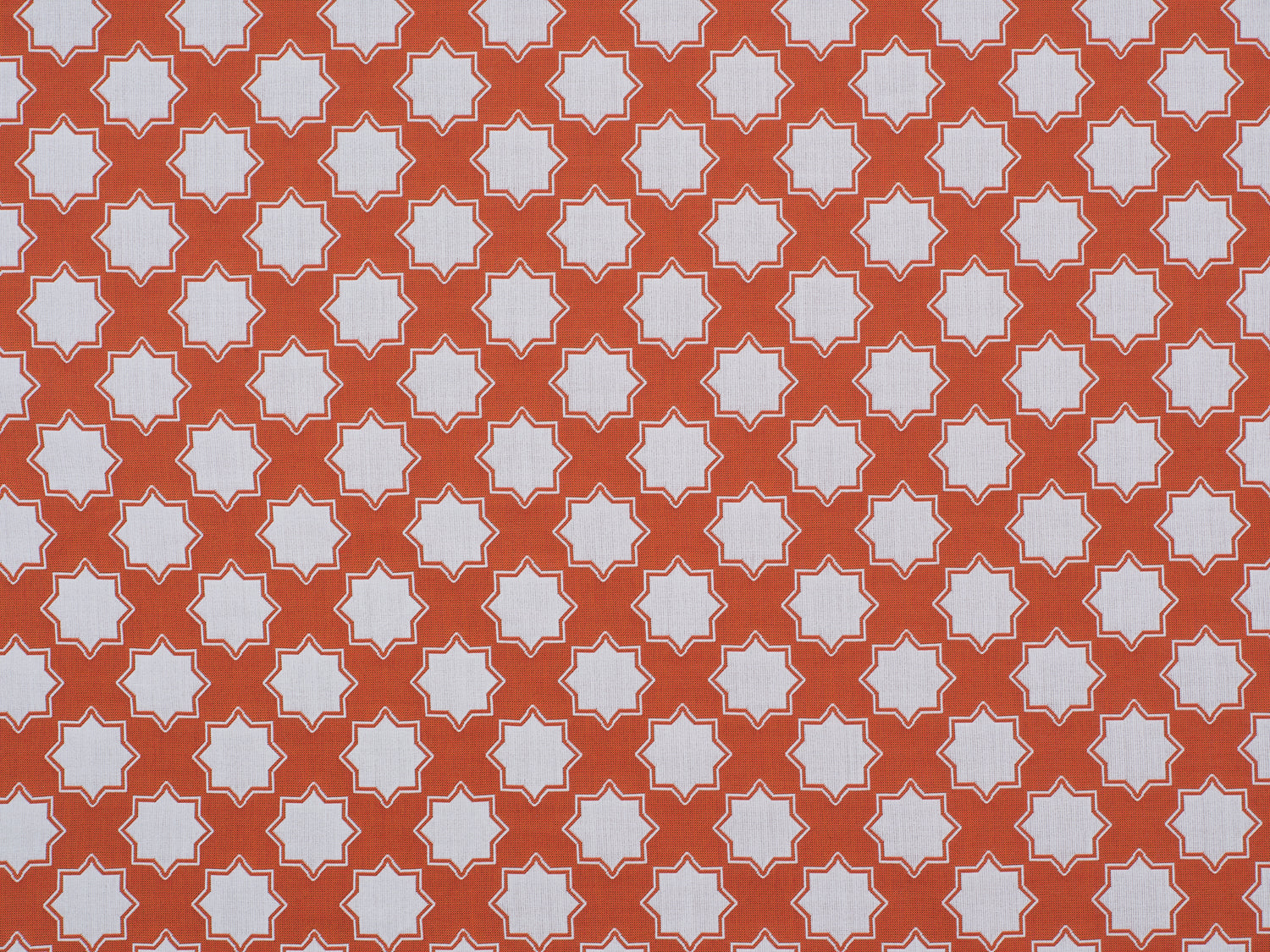 Moroccan star performance fabric in orange and white. 