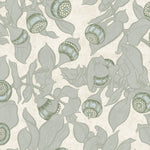 Patterned wallpaper with blooms and leaves in green on a light grey-green background