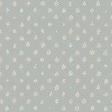 Detail of wallpaper in a repeating leaf print in cream on a light blue field.