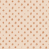 Detail of wallpaper in a repeating leaf print in burnt orange on a cream field.