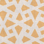 Detail of fabric in a geometric lattice print in yellow on a cream field.