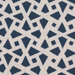 Detail of fabric in a geometric lattice print in navy on a cream field.