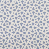 Detail of fabric in a geometric lattice print in blue on a cream field.