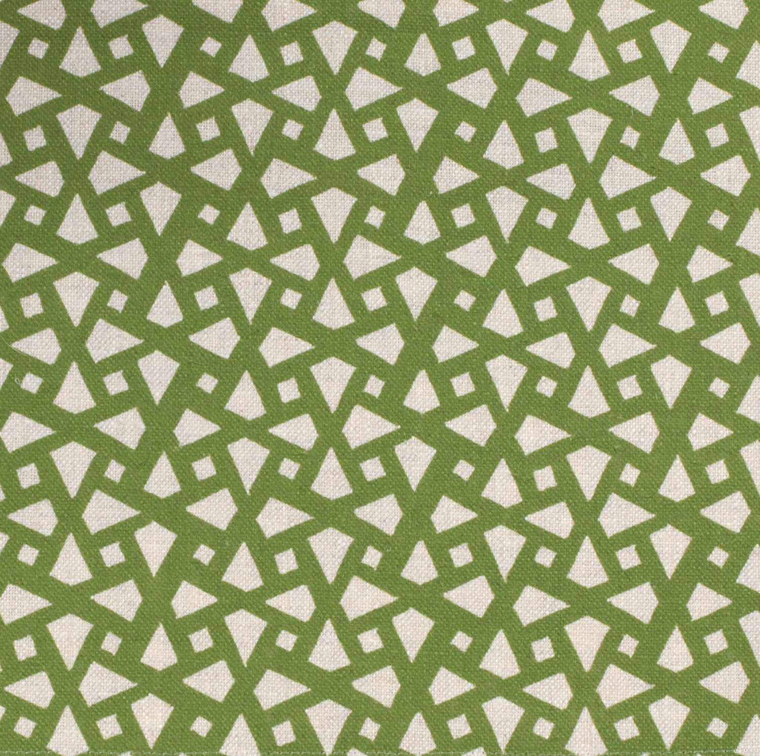 Detail of fabric in a geometric lattice print in green on a greige field.