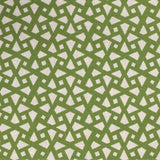 Detail of fabric in a geometric lattice print in green on a greige field.