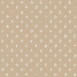 Detail of fabric in a repeating leaf print in cream on a tan field.