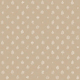 Detail of fabric in a repeating leaf print in cream on a tan field.