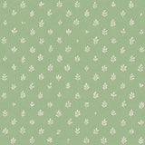 Detail of fabric in a repeating leaf print in cream on a green field.