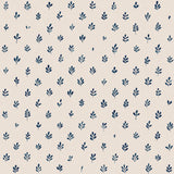 Detail of fabric in a repeating leaf print in navy on a cream field.