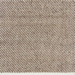 Detail of a flatwoven rug, with a brown and white twill design
