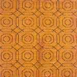 Handmade rug sample in a hexagonal linear motif in ochre with accents of navy. 